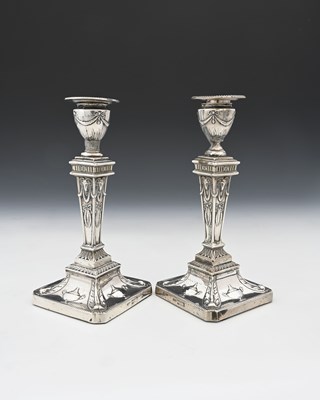 Lot 61 - A pair of Edwardian silver candlesticks,...