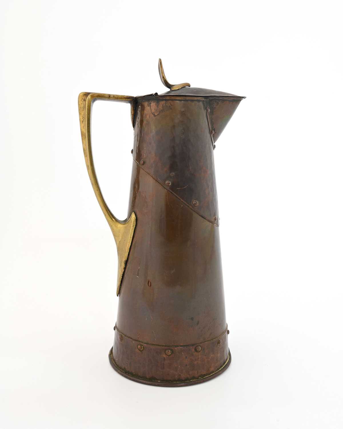 Lot 171 - An Arts and Crafts copper and brass jug,...