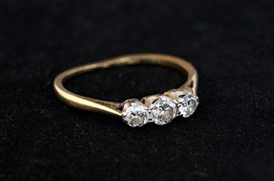 Lot 2 - An 18 carat gold three stone diamond ring,...