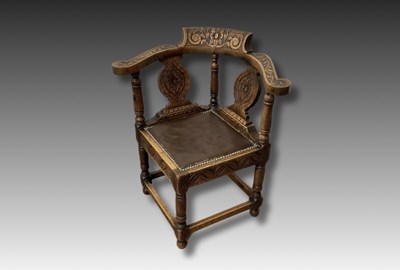 Lot 849 - An Edwardian oak carved corner chair with...