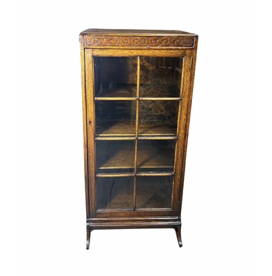 Lot 897 - A glazed oak side table cabinet with a carved...