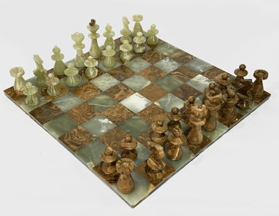 Lot 396 - A green onyx and hardstone chess board on a...