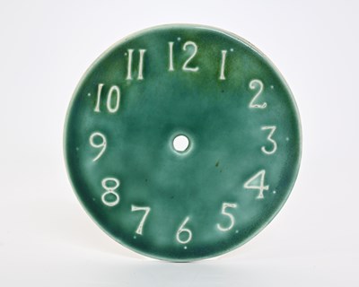 Lot 602 - Ruskin Pottery, a Souffle glazed clock face,...