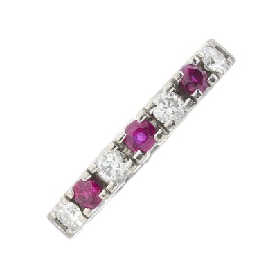 Lot 215 - An 18ct gold ruby and diamond half eternity ring