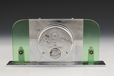 Lot 199 - An Art Deco chrome and green glass clock,...