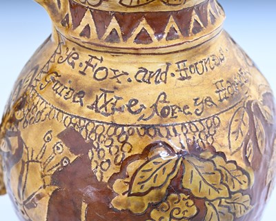 Lot 757 - An English slipware jug, sgraffito decorated...