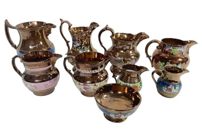 Lot 42 - Copper lustre jugs of varying forms with a...