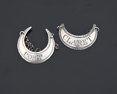 Lot 166 - Two George III silver crescent form wine...