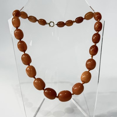 Lot 664 - An amber bead necklace, with 18ct gold clasp