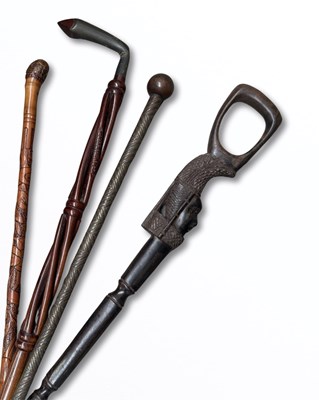 Lot 567 - African walking sticks, an elaborately...