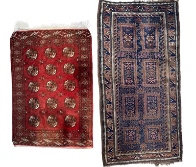 Lot 577 - Two handmade oriental/tribal rugs, red ground...