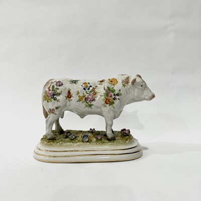 Lot 169 - A floral printed china cow with 'R' and...