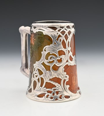 Lot 136 - A silver overlay ceramic tankard, J B Owens,...