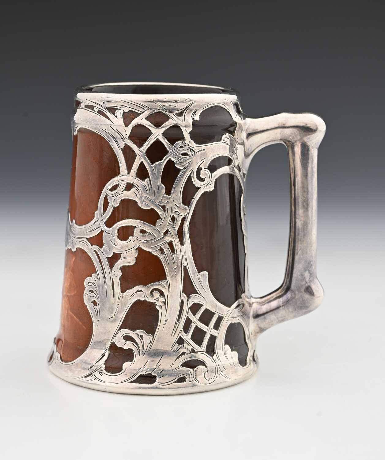 Lot 136 - A silver overlay ceramic tankard, J B Owens,...