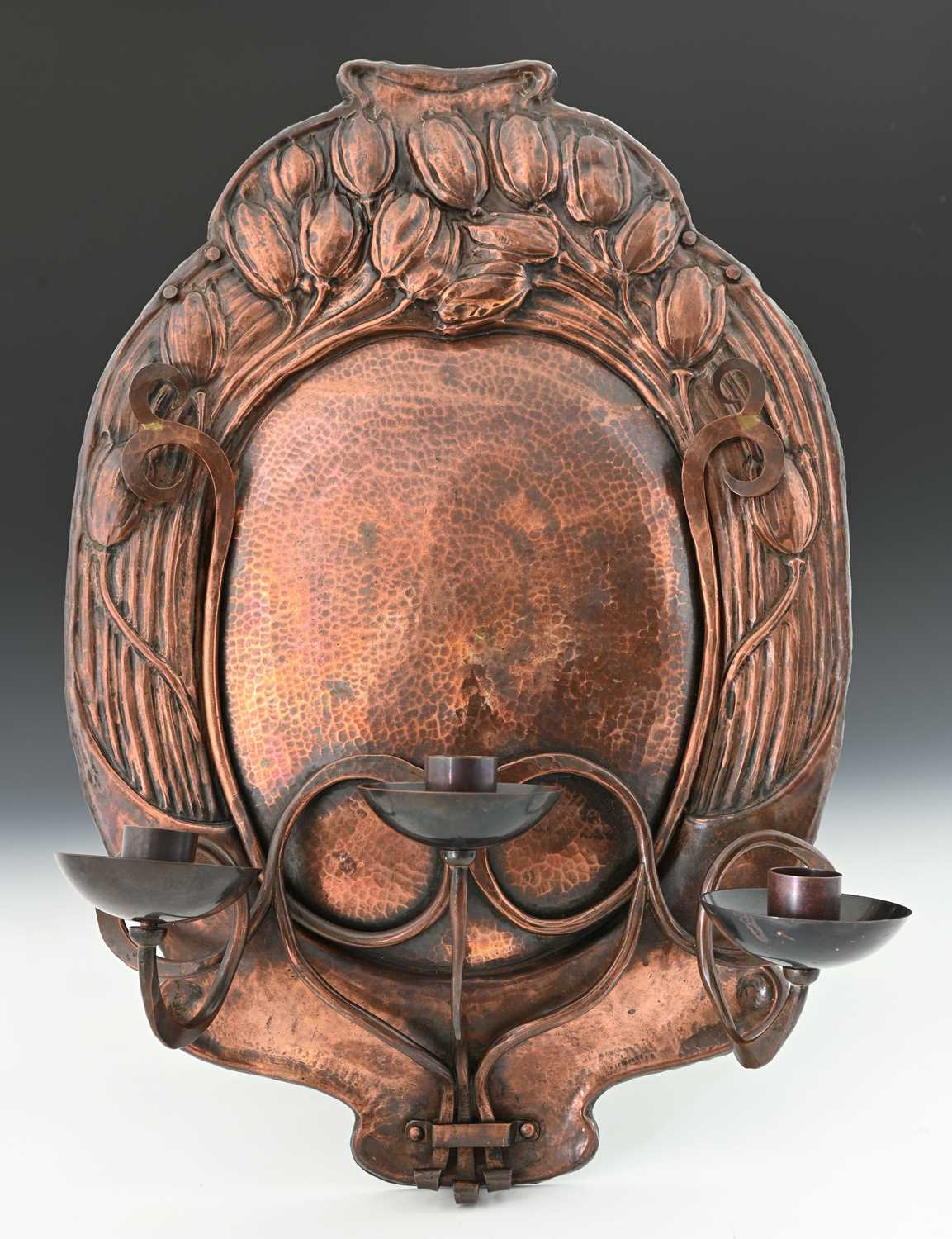 Lot 164 - An Arts and Crafts copper three branch wall...