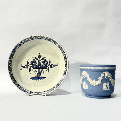 Lot 220 - A handpainted blue and white faience plate...