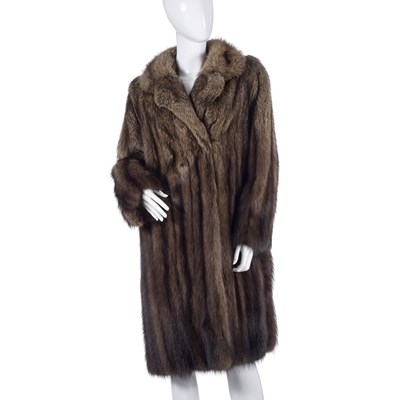 Lot 510 - A knee-length raccoon fur coat.