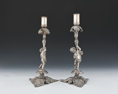 Lot 1 - A pair of white metal figurative candlesticks,...