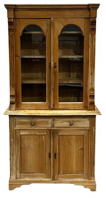 Lot 388 - A traditional stripped pine pier cabinet, the...