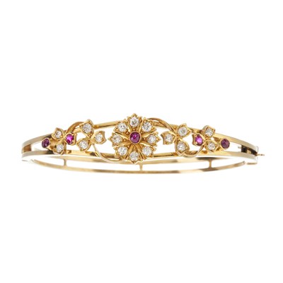 Lot 22 - A late Victorian gold ruby and diamond floral bangle bracelet