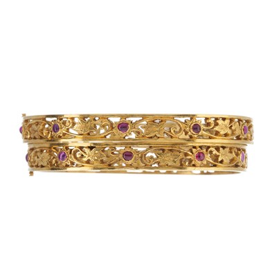 Lot 49 - Two gold pink gem foliate openwork bangle bracelets