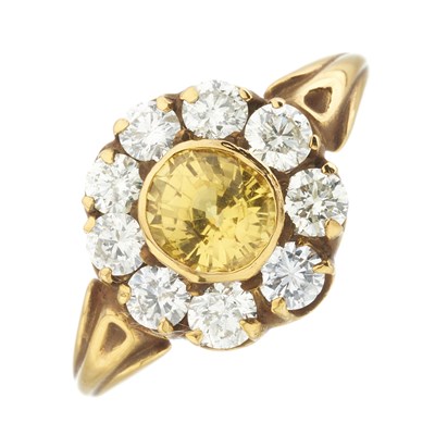 Lot 157 - An 18ct gold yellow sapphire and diamond cluster ring