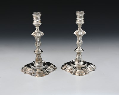 Lot 63 - A pair of George II silver cast candlesticks,...