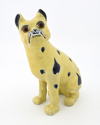 Lot 690 - A faience figure of a pug dog, in the...