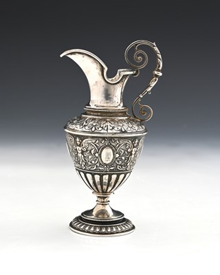 Lot 138 - A Continental silver-coloured metal ewer or...