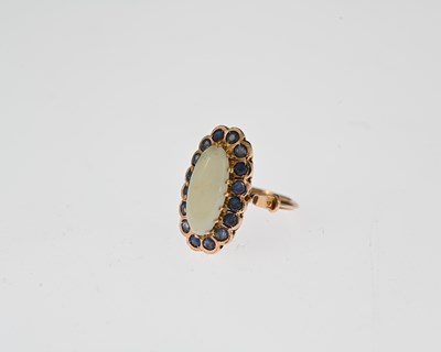 Lot 16 - An early 20th century gold opal and sapphire cluster ring