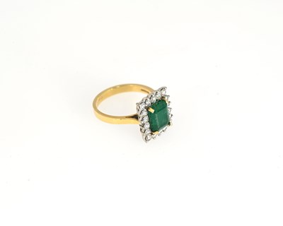 Lot 53 - An 18ct gold emerald and diamond cluster ring