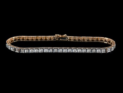 Lot 19 - A 9ct gold diamond line bracelet