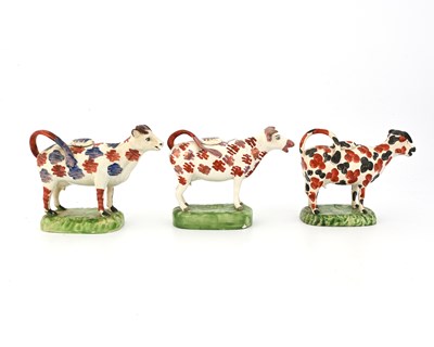 Lot 830 - Three Staffordshire sponge decorated cow...