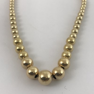 Lot 307 - A 14ct gold bead necklace