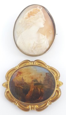 Lot 302 - A Victorian pinchbeck brooch, with an oval painting on copper, and an oval shell cameo brooch