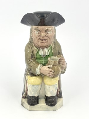 Lot 1046 - A Staffordshire Toby jug and beaker lid, Ralph...