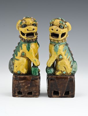 Lot 369 - A pair of Chinese earthenware Foo lion dog...