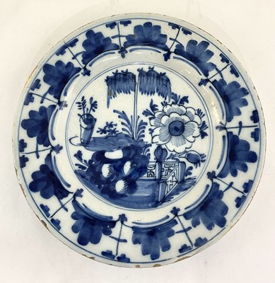 Lot 130 - A Dutch Delft plate, painted in underglaze...