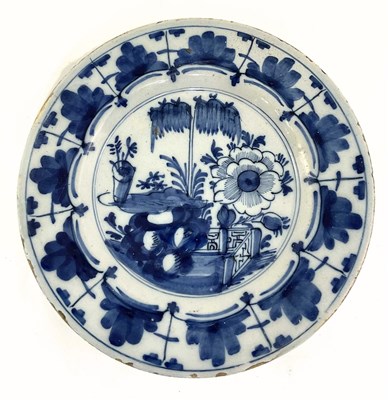 Lot 130 - A Dutch Delft plate, painted in underglaze...