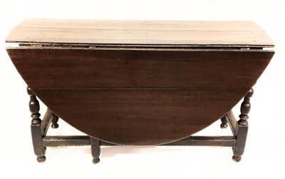 Lot 399 - A stained oak drop leaf gate-legged table with...