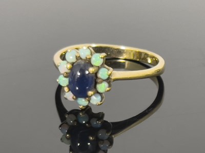 Lot 175 - A 9ct gold sapphire and opal cluster ring, the...