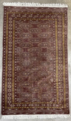 Lot 376 - A brown and gold geometric patterned wool...