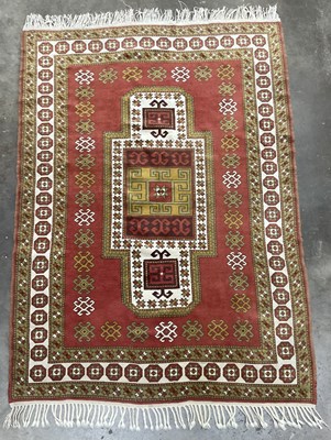 Lot 341B - Orange and green on red ground tribal rug,...