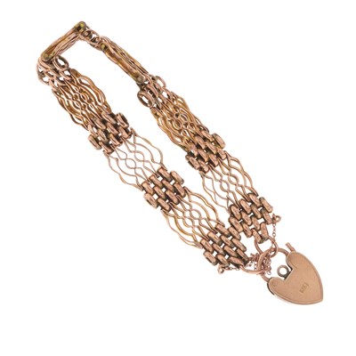 Lot 12 - An early 20th century 9ct gold gate bracelet,...