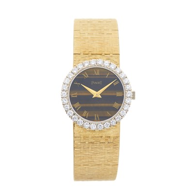 Lot 309 - Piaget - A diamond set bracelet watch with tiger's eye dial