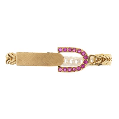 Lot 231 - A 1980s 18ct gold ruby stirrup bracelet