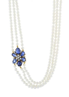 Lot 188 - A cultured three-row pearl necklace, with gold carved sapphire and diamond clasp