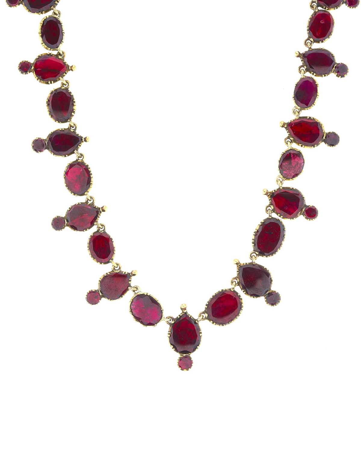 Lot 35 - A late Georgian gold, foil back garnet riviere...