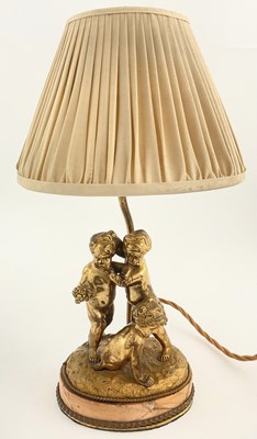 Lot 192 - A gilded metal table lamp, cast in the form of...