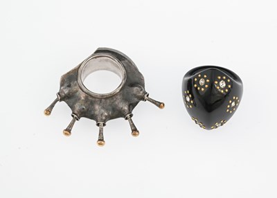 Lot 55 - An unusual silver ring, and a jet type ring, in the style of Jacqueline Cullen